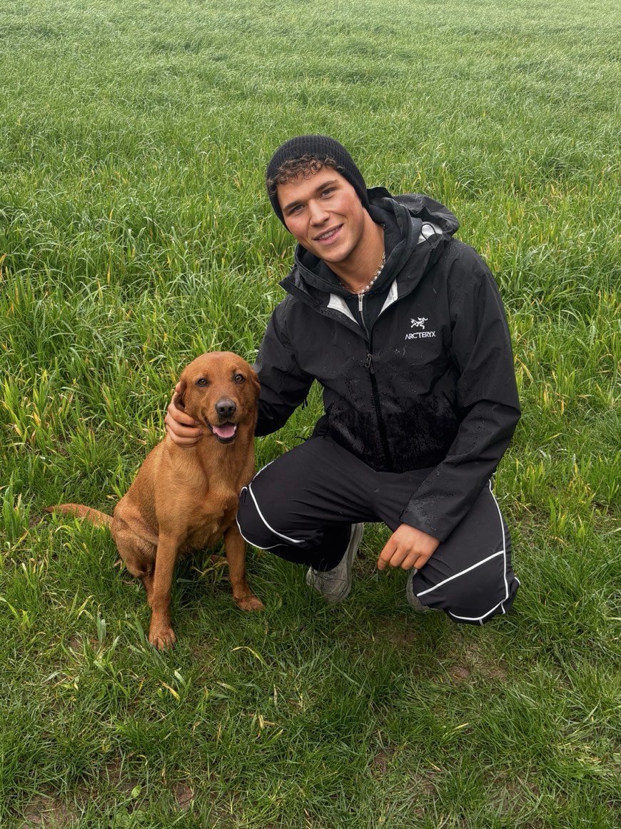 Crouched on the grass with one of my dogs